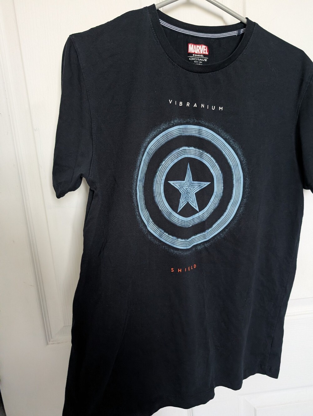 Marvel Men’s Black Tee with Light Blue Vibranium Shield Graphic